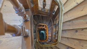 A wooden spiral staircase with a central open space.