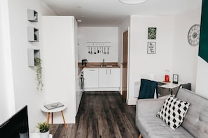 Cozy living space with a central kitchen, comfortable sofa, and modern amenities.