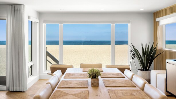 A modern dining area with a view of the beach.