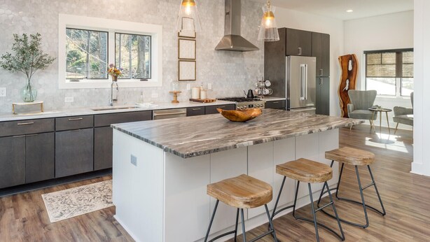 A modern kitchen with a large island, bar stools, stainless steel appliances, and pendant lighting. - Long Range Mtn Views Next to Jump Off Rock! Ultra Modern, Very Unique Open Floor (Hendersonville)