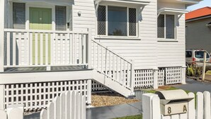 A two-story house with a front porch, a green door, and a mailbox labeled "8 Mail A". - Sage Cottage! CBD Perfection! (East Toowoomba)