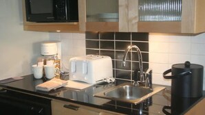 A modern kitchen with a microwave, toaster, sink, and coffee maker. - Bahia at Sandestin Studio 3rd Floor Pool View ! (Miramar Beach)