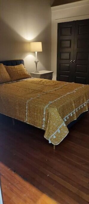 Cozy retreat with a large bed and bedside lamp.