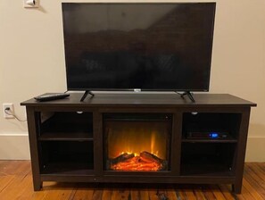 Enjoy a warm ambiance with a fireplace and flat-screen TV.