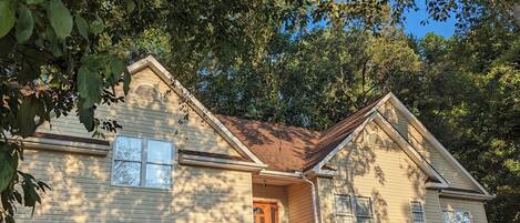 A two-story house with a front porch, a garage, and a staircase leading to the second floor.