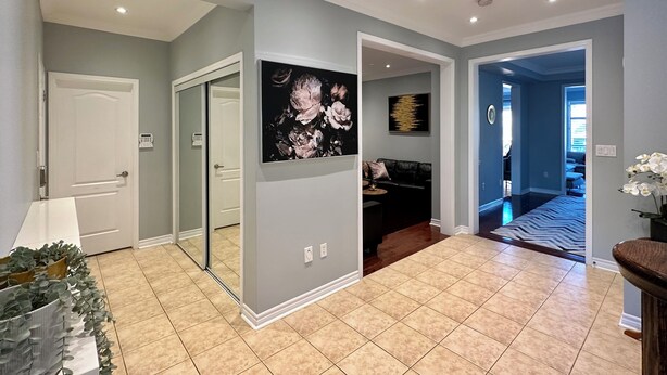 A spacious living area with a large mirror, a painting, and a modern fireplace. - Cozy 5 Bedroom House in Mississauga, On  (Mississauga)
