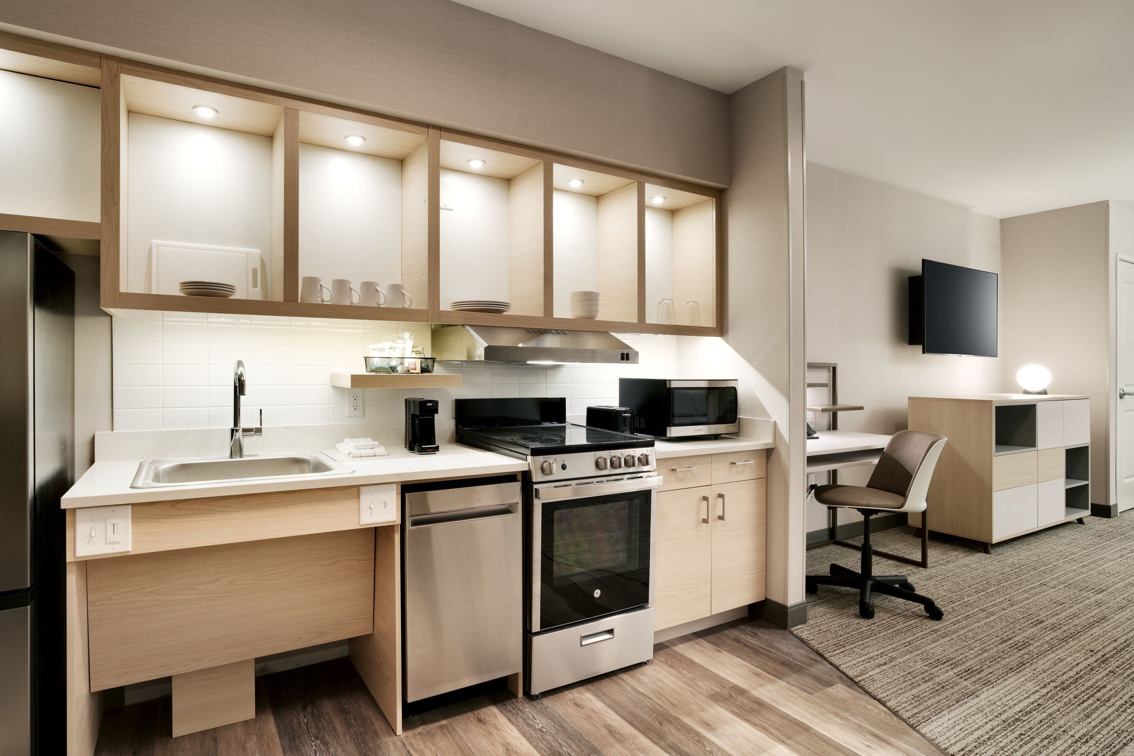 A modern kitchen with built-in appliances, a dishwasher, and a microwave.
