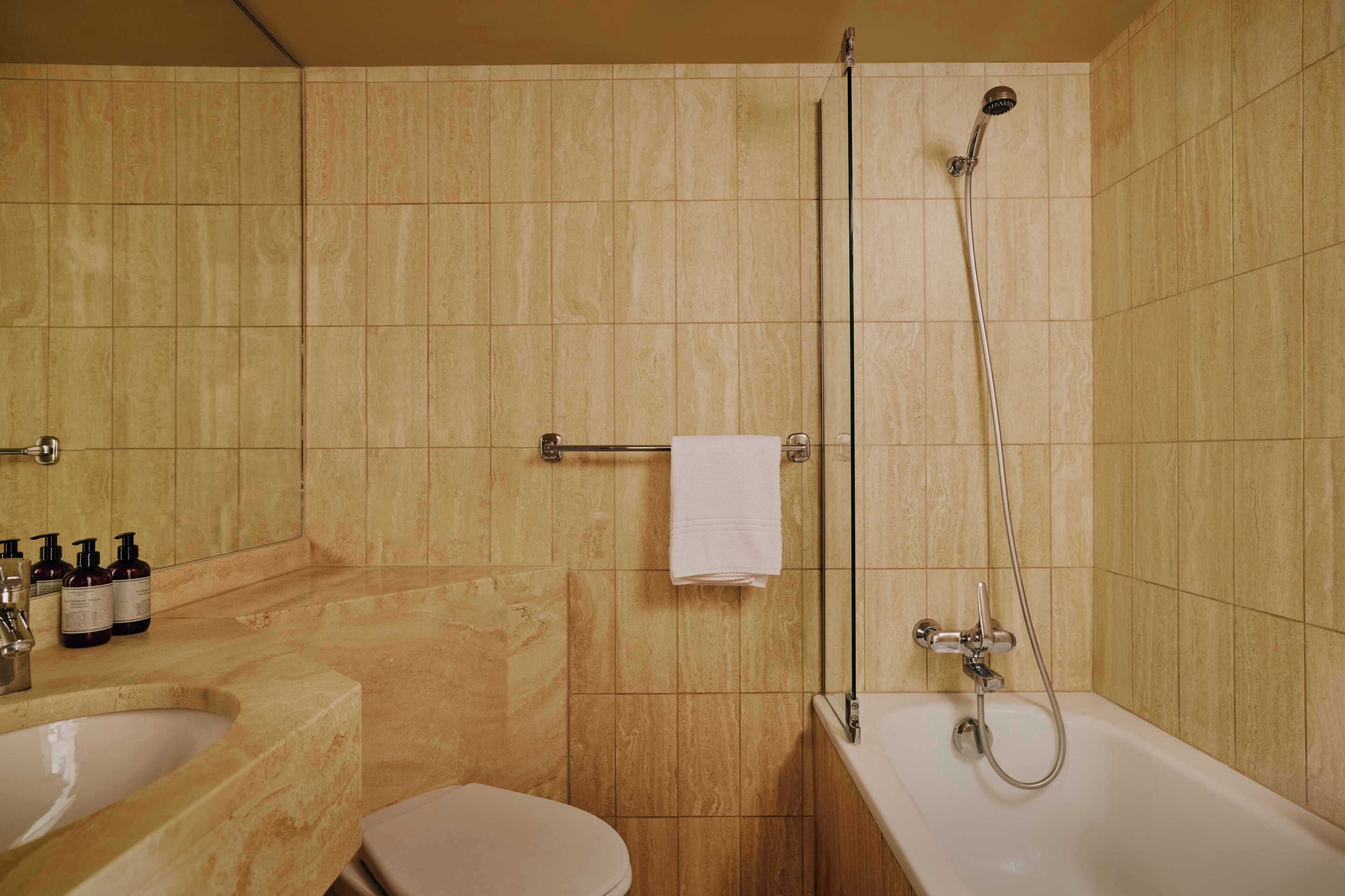 A bathroom with a bathtub, a shower, a toilet, and a sink.