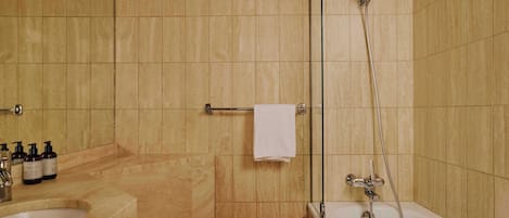 A bathroom with a bathtub, a shower, a toilet, and a sink.