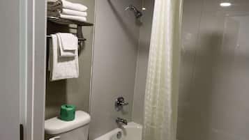 A bathroom with a toilet, sink, and shower.