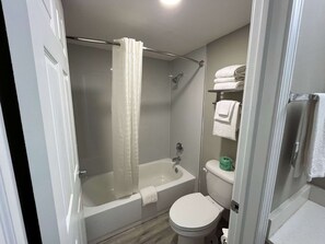 Bathtub, towels, soap, shampoo