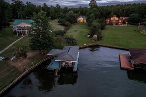 A lakeside property with a dock, a house, and a large lawn. - Sleeps 14, Game Room,Movie Theater,Dock +MORE (Eatonton)