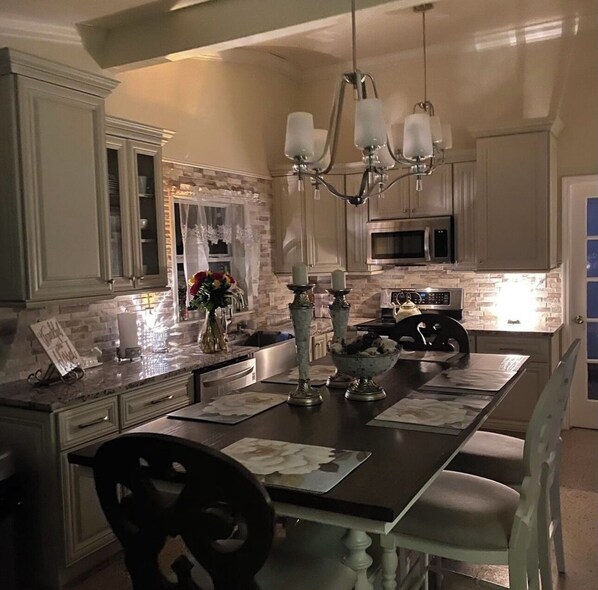 Enjoy cooking in this well-equipped kitchen with a central island, microwave, and refrigerator.