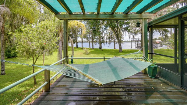 A hammock under a wooden pergola with a view of a lake and trees. - Waterfront Georgetown Retreat on Lake George! (Georgetown)