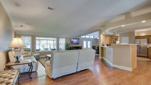 A spacious living room with a sofa, a coffee table, and a TV. - Waterfront Georgetown Retreat on Lake George! (Georgetown)