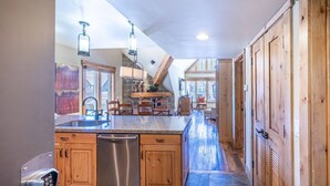 A kitchen with a central island, wooden cabinets, and a built-in dishwasher. - Labor Day Sale - Limited Time Offer, Save up to 30% (Park City)