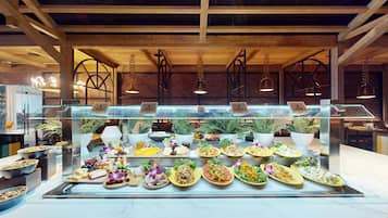 A buffet with various food items and a glass display case.