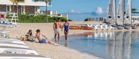 On the beach, white sand, beach cabanas, sun loungers
