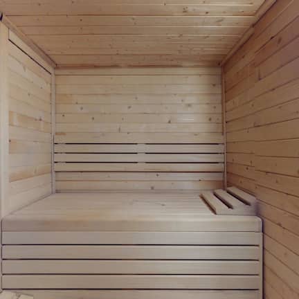 A sauna room with wooden walls and benches.