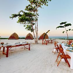 On the beach, white sand, beach cabanas, sun-loungers