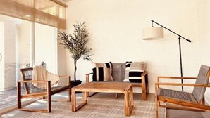 A modern living room with a wooden coffee table, two armchairs, a sofa, and a floor lamp. - Sun & Fun in Fountain Hills- HENDVR2 (Fountain Hills)