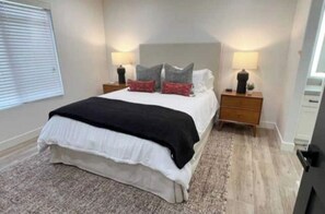 mater bedroom with new comfortable queen bed and smart TV