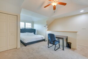 A bedroom with a bed, desk, chair, ceiling fan, and a window. - Owings Mills Townhouse: 8 Mi to Liberty Reservoir! (Owings Mills)