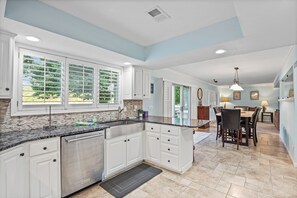 Enjoy meals in this well-lit kitchen with a dishwasher and dining area.