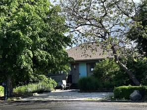 A house with a front porch, a mailbox, and a driveway.