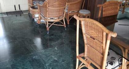 Open front yard with mature trees for relaxation..