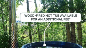 A hot tub surrounded by trees.
