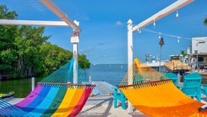 A hammock setup on a dock with a view of the water and greenery. - Key Largo Home 3 Bed/3 Bath (Key Largo)