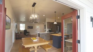 A spacious kitchen with wooden countertops, a central island, and pendant lighting. - New modern farm house on the Still Water Ranch. (Montrose)