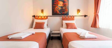A hotel room with two single beds, a nightstand, a painting on the wall, and a window with curtains.