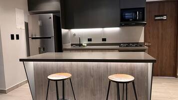 Microwave, coffee/tea maker, cookware/dishes/utensils, dining tables