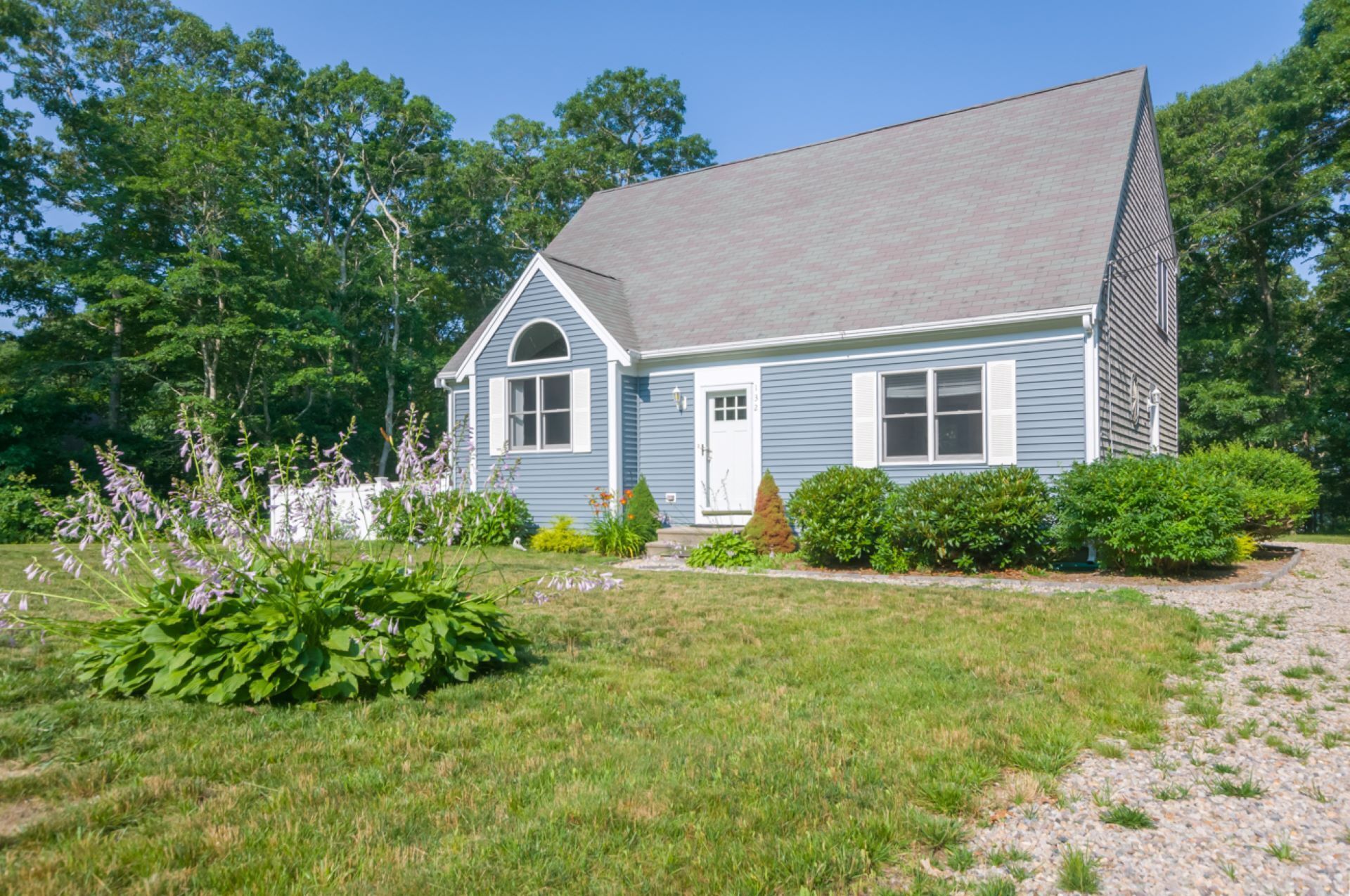 Cape Cod pet friendly home with deck with gas grill, back yard patio with fire pit, and central AC