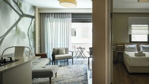 A modern hotel room with a large window, a sofa, a desk, and a bed. - White Blossom Dizengoff CTR by SeaN'Rent (Tel Aviv)