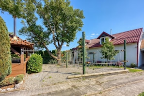 A residential area with a paved courtyard, a wooden structure, and a house with a red roof. - Hedonia Estate /w Sauna and Jacuzzi Near Varaždin, Majerje, Croatia (Majerje)