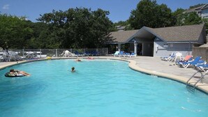 A swimming pool with lounge chairs and a covered area. - Beautiful View of Main Channel 2 Bed/2 Bath Condo w/ Pools, Pickleball & Tennis! (Village of Four Seasons)