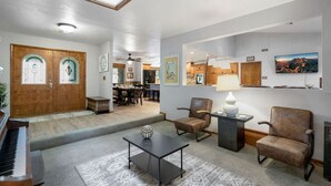 A spacious living room with a piano, comfortable seating, a coffee table, and a TV. - *Large Groups*Sleeps 20*Must See (Flagstaff)