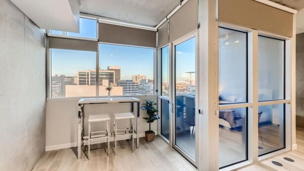 A modern apartment with a balcony, large windows, and a city view. - Sparkling Juhl byFremont-1 queen 1 sofa bed TONS of Amenities (Las Vegas)
