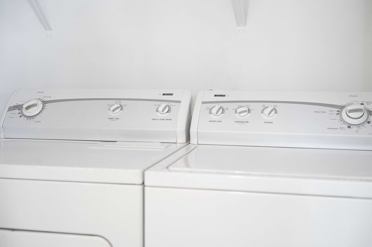 Two front-loading washing machines with control panels.