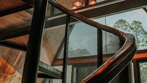 A spiral staircase with metal railings and wooden steps, leading to a higher floor. - K NAJ Community (Omitlán de Juárez)