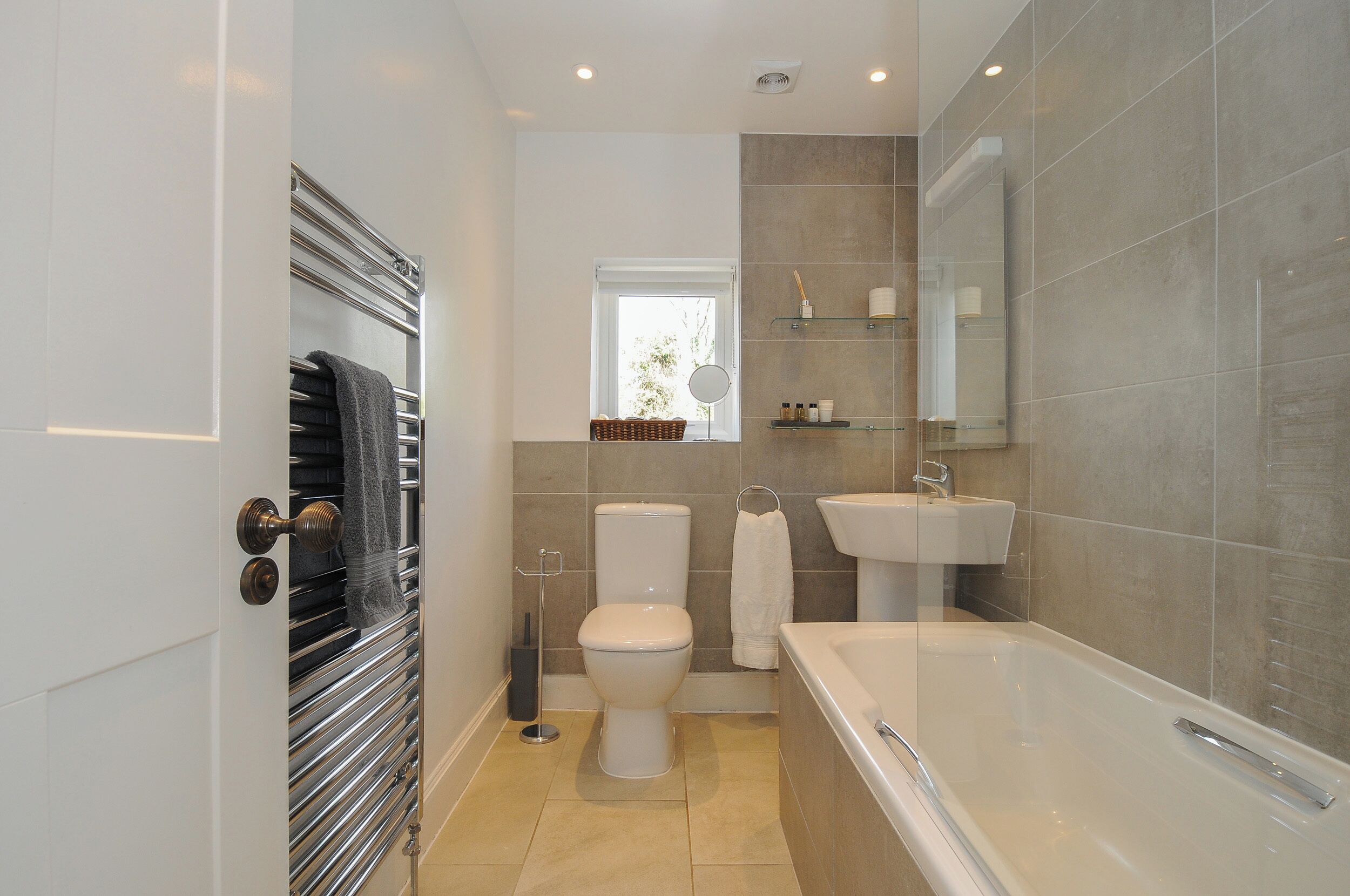 Une salle de bain moderne équipée d’une baignoire, de toilettes et d’un lavabo.