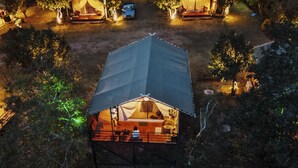 A campsite with three tents, each with a roof and surrounded by trees. - NUYU Khaoyai (Pak Chong)