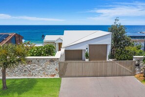 Enjoy stunning ocean views from this coastal residence with a spacious driveway and well-maintained lawn.