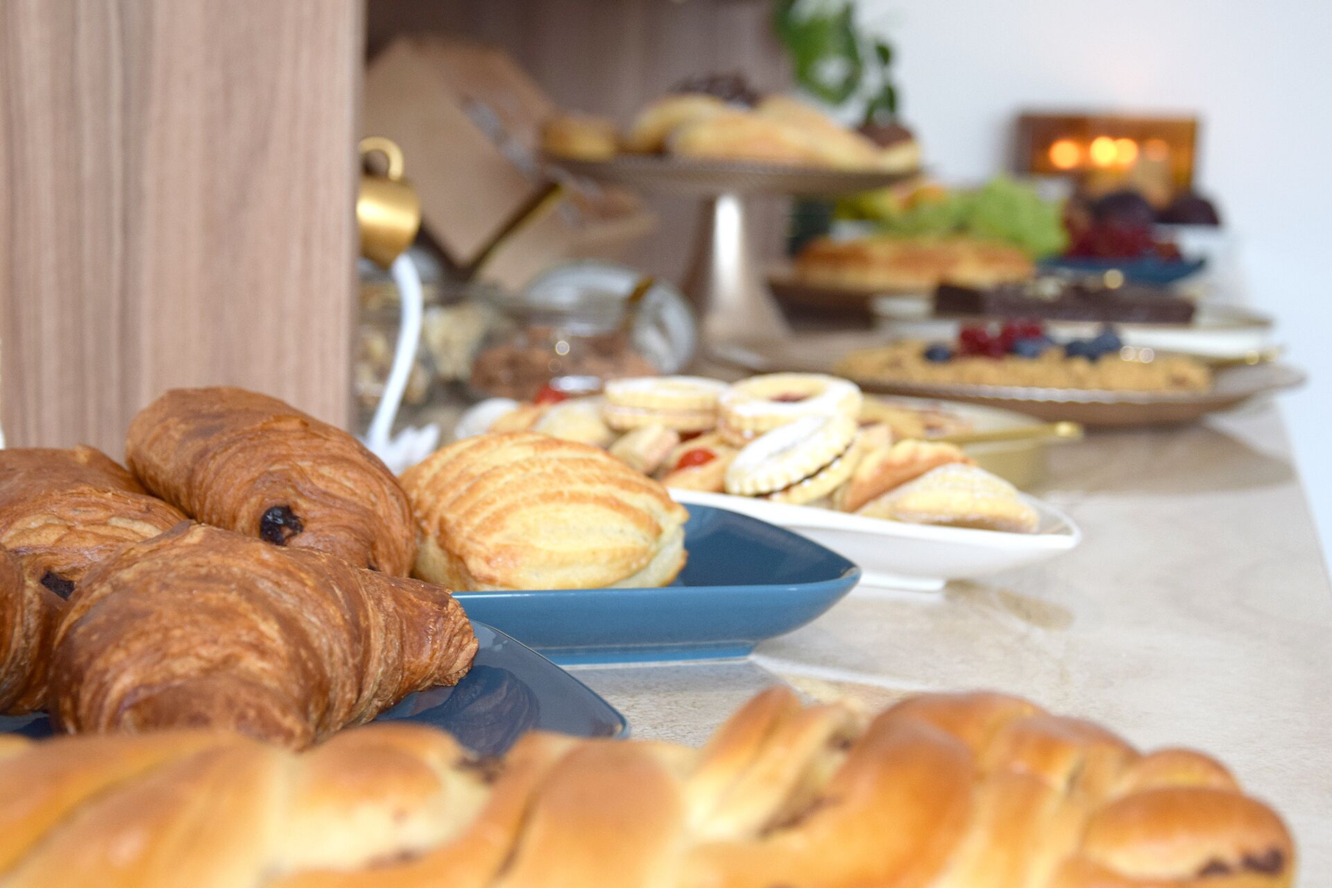 A variety of pastries and baked goods on display, including croissants and cookies.