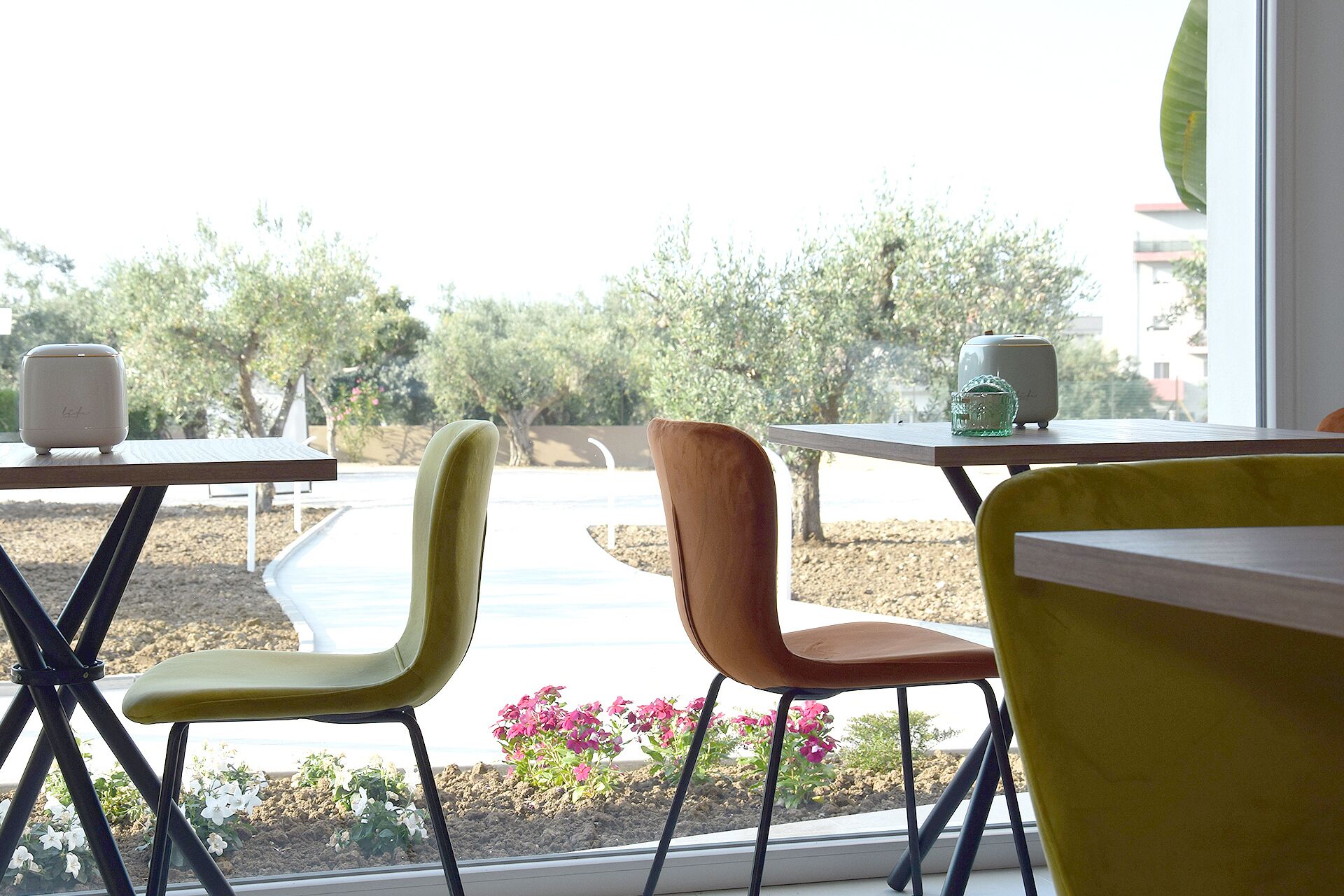 A dining area with outdoor seating, tables, and chairs.