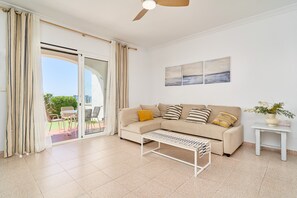 A living room with a sofa, a coffee table, a side table, and a ceiling fan. - 'Frontline Vacation Home A86' Apartment with Sea Views, Shared Pool and Wi-Fi (TORROX COSTA)