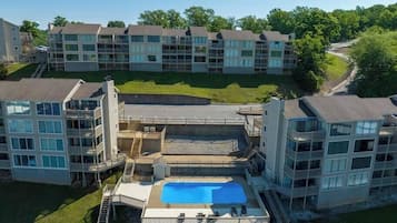 Un immeuble résidentiel à plusieurs étages doté d’une piscine et d’un espace vert.